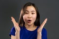 Asian woman with long hair very glad and happy, she smiling. Surprised excited shocked korean girl on grey studio Royalty Free Stock Photo