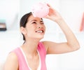 Asian woman looking through an empty piggy bank Royalty Free Stock Photo