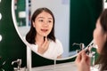 Asian woman looking herself on the mirror Royalty Free Stock Photo