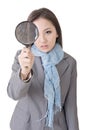 Asian woman looking through a magnifying Royalty Free Stock Photo