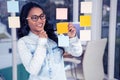 Asian woman looking at sticky notes Royalty Free Stock Photo