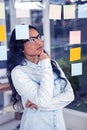 Asian woman looking at sticky notes Royalty Free Stock Photo