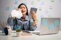 Asian woman looking at tablet reading news crying and using tissue paper at home office. WFH. Work from home. Prevention