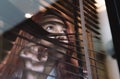 Diverse Asian girl peeping through window blinds Royalty Free Stock Photo