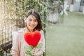 Asian woman in love holding red love hearts flower. Valentine day concept Royalty Free Stock Photo