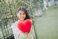 Asian woman in love present heart shape flower