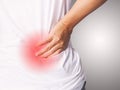 Asian woman with lumbar pain, backache and massage on waist to pain relief Royalty Free Stock Photo