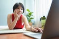 Asian woman lying on the floor using Laptop Royalty Free Stock Photo