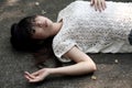 Asian woman lying on the rough cement floor