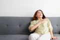 Asian woman lying on the sofa in the house She had a sharp pain in her heart Royalty Free Stock Photo