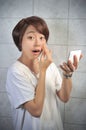 Asian woman makeing up her face Royalty Free Stock Photo