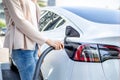 Woman charging electric car