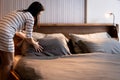 Asian woman making bed,changing bedding in room,housewife cleaning pillow sheet and blanket,tidying up the bedroom,doing Royalty Free Stock Photo