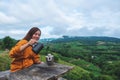 A woman making drip coffee with a beautiful green mountain and nature in background Royalty Free Stock Photo