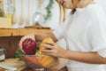 Asian woman making healthy food standing happy smiling in kitchen preparing salad. Royalty Free Stock Photo