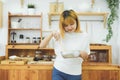 Asian woman making healthy food standing happy smiling in kitchen preparing salad. Royalty Free Stock Photo