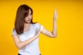 Asian woman making stop gesture isolated