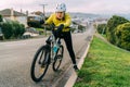 18/04/2020-Asian woman making uphill with mountain bike. A woman very tired and stop on street At Oamaru, New Zealand