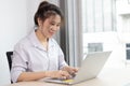 Asian woman making video calls on her laptop in the private office of her home Royalty Free Stock Photo