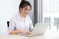 Asian woman making video calls on her laptop in the private office of her home Royalty Free Stock Photo