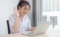 Asian woman making video calls on her laptop in the private office of her home Royalty Free Stock Photo