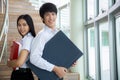 Asian woman and man student read text book in her university library Royalty Free Stock Photo