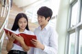 Asian woman and man student read text book in her university library Royalty Free Stock Photo