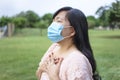 Asian woman in mask and feels unhealthy put hand where is lungs, suffering from repeated coughing and breath difficulties