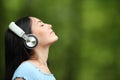 Asian woman meditating listening guide on headphones Royalty Free Stock Photo