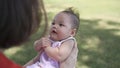 Asian woman mother playing with happy baby infant in garden on sunny day under tree on picnic vacation. smile baby happy fun Royalty Free Stock Photo