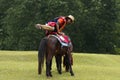 Asian woman mounting horse