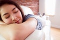 Asian woman napping on couch Royalty Free Stock Photo