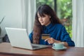 asian woman online shopping using credit card with laptop computer on wood table at cafe restaurant,Digital lifestyle concept. Royalty Free Stock Photo