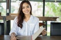 Asian woman open menu for ordering in coffee cafe and restaurant Royalty Free Stock Photo