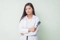 Asian woman ophtalmologist standing at hospital and looking at camera.