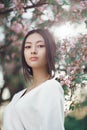 Asian woman outdoors on spring against flower blossom Royalty Free Stock Photo