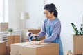 Asian Woman Packing Boxes for Moving Out Royalty Free Stock Photo