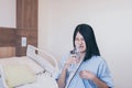 Asian woman patient having or symptomatic reflux acids at hospital,Gastroesophageal reflux disease,Drinking water Royalty Free Stock Photo