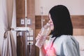 Asian woman patient having or symptomatic reflux acids at hospital,Gastroesophageal reflux disease,Drinking water Royalty Free Stock Photo