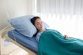 Asian woman patient sleeping on sickbed at hotpital after take a medicine and the relatives visit