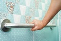 Asian woman patient use toilet support rail in bathroom, handrail safety grab bar, security in nursing hospital