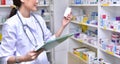 Asian woman pharmacist filling prescription in pharmacy Royalty Free Stock Photo