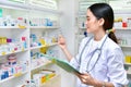 Asian woman pharmacist filling prescription in pharmacy Royalty Free Stock Photo