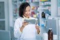Pharmacist packs medicines in plastic