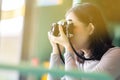 Asian woman photographer take a picture by film camera Royalty Free Stock Photo