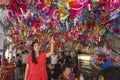 Asian woman picking up lantern in a dim sum restaurant during Mid Autumn Festival, a traditional culture for Chinese ethnic celebr