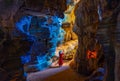 Asian woman in a pink dress visits a blue cave in Tak Province, Thailand