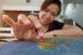 Asian woman pinned on the map