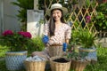 Asian woman plant a flower in her garden