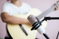 Asian woman play acoustic classic guitar for jazz and easy listening song and record with microphone select focus shallow depth of Royalty Free Stock Photo